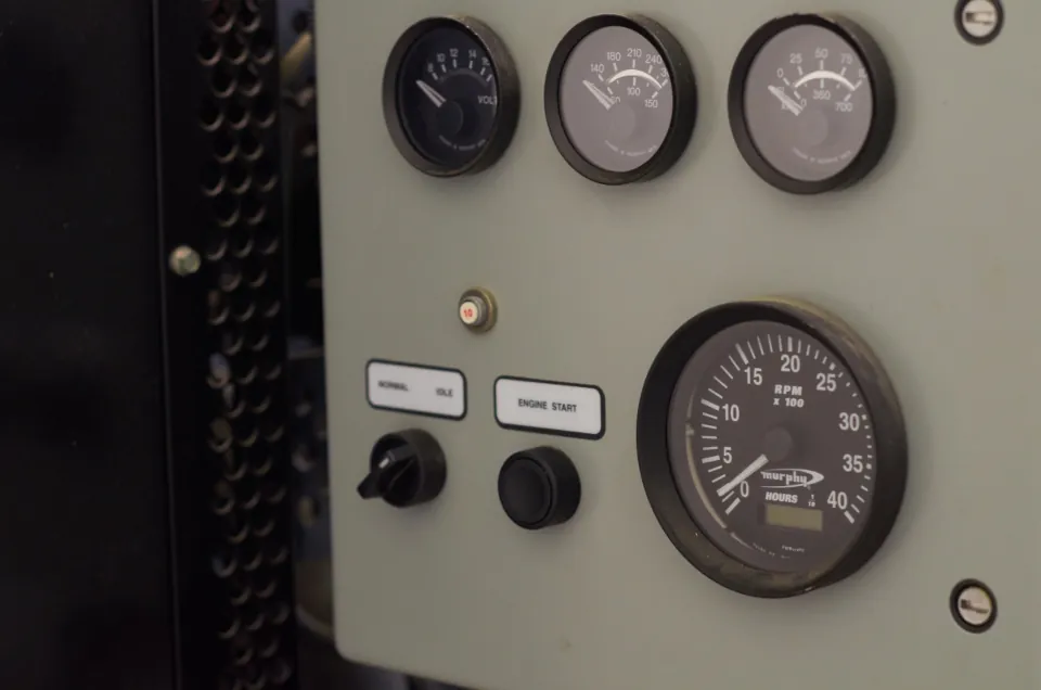 Analog gauges and switches on an industrial control panel